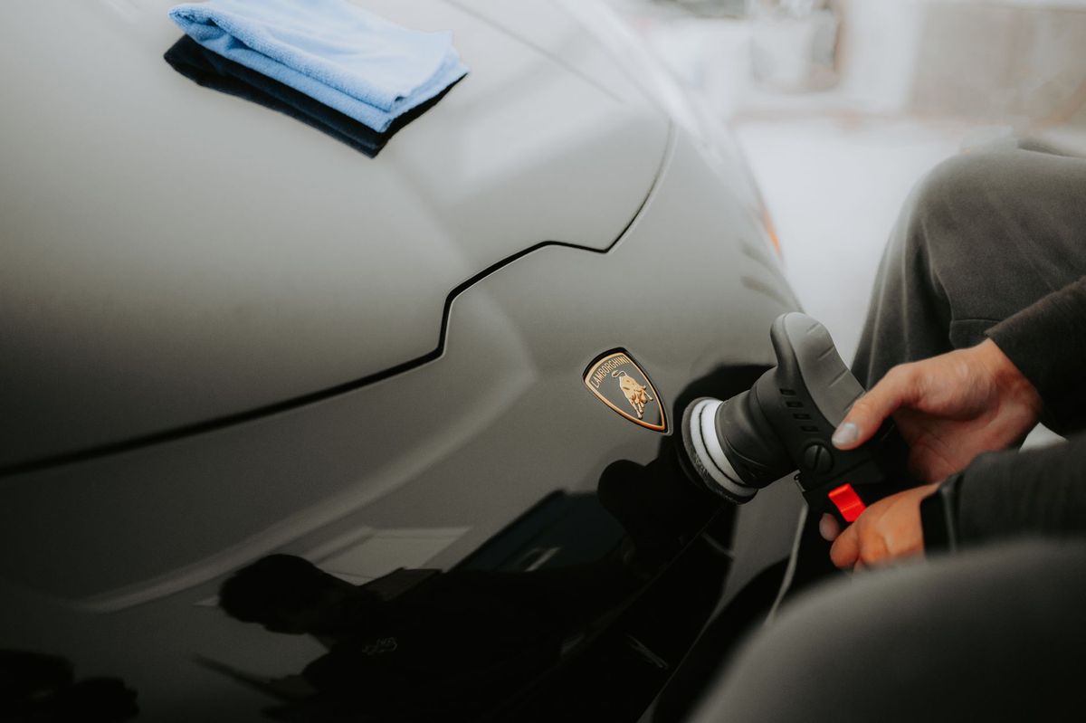 North Jersey Detailing specialist polishing a black vehicle